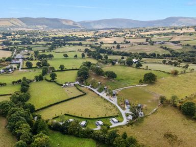 An aerial view of fields and caravans at Fawn’s Rest Nantmel near Rhayader