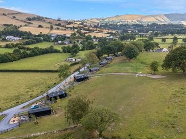 An aerial view of fields and buildings at Fawn’s Rest Nantmel near Rhayader