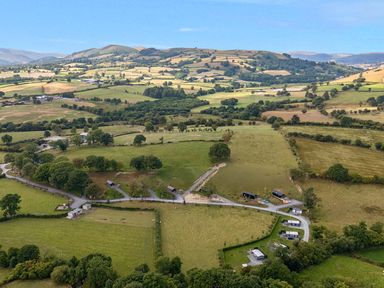 A panoramic view of fields and hills at Doe Lodge in Nantmel near Rhayader
