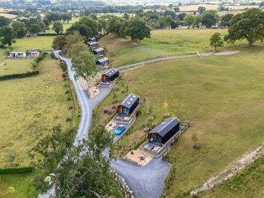 A view of cabins and a gravel road at Doe Lodge near Rhayader