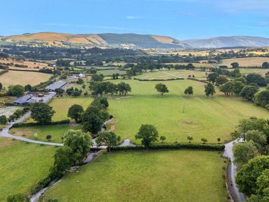 An aerial view of fields and trees at Doe Lodge in Nantmel near Rhayader