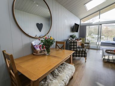 A dining area with a table and chairs at Doe Lodge Nantmel near Rhayader