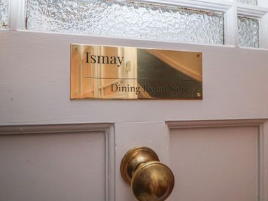 A door with a brass plate reading Ismay Dining Room Suite and a brass doorknob at Ismay Dining Room Suite - Titanic Interest in Waterloo Merseyside