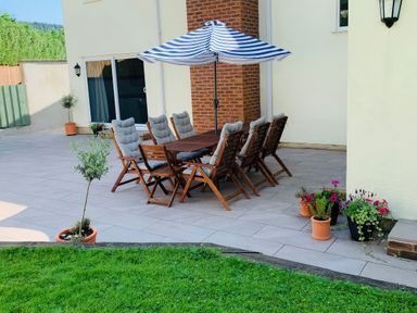 An outdoor dining area with table and chairs at Brooklands in Uplyme