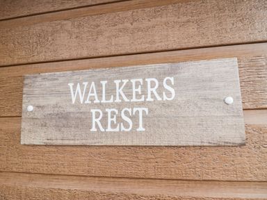 A wooden sign with the words Walkers Rest mounted on a wooden wall at Walkers Rest in Warton near Carnforth