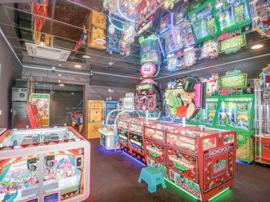 An arcade room with claw machines and coin pusher games including monopoly at The Olive Lodge 227 Sycamore in New Milton