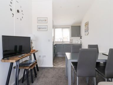 A dining area with a table and chairs at Bonny Bay in Wilsthorpe near Bridlington