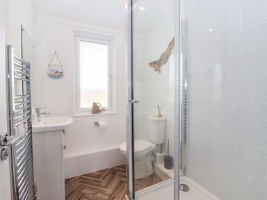 A bathroom with a shower, toilet, and sink at Bonny Bay in Wilsthorpe near Bridlington
