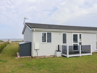 A house with a balcony and garden at Bonny Bay Wilsthorpe near Bridlington