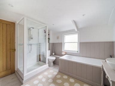 A bathroom with a shower enclosure toilet bathtub and a sink at Clematis House in St Columb Major