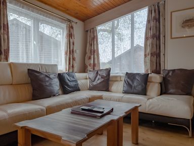 A living room with a sofa and coffee table at Willow in Swanage