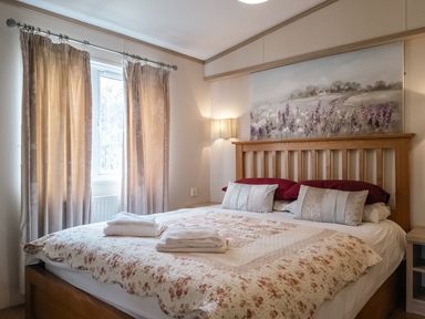 A bedroom with a bed and curtains at Willow in Swanage