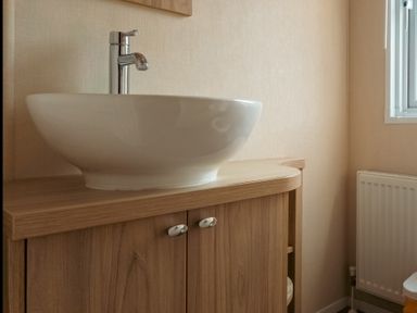 A bathroom with a sink and faucet at Willow in Swanage