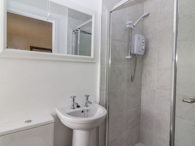 A bathroom with a sink toilet and shower at The Artist's Barn in Ayle near Cappawhite
