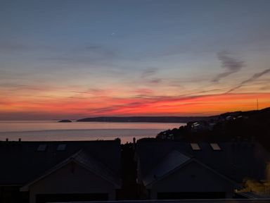 A view of the ocean and sunset at Looe Island View in Downderry