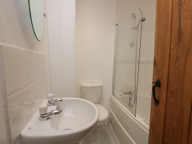 A bathroom with a sink toilet and bathtub with shower at Winder Barn in Askham Cumbria