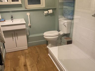A bathroom with sink, toilet, and shower at Seaspray in St Bees