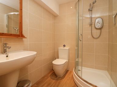 A bathroom with a sink, toilet, and a glass-enclosed shower at Fairfield View in Ambleside