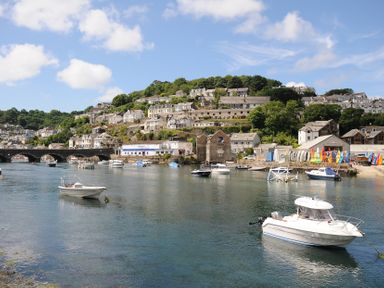 A view of a harbor with boats and houses at 3 River View in Looe