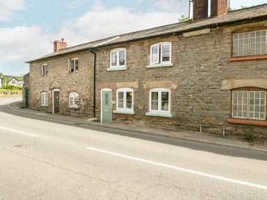 Exterior of stone terraced houses along a curved road at 4 Wallflower Row Mordiford near Hereford