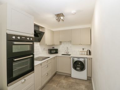 A kitchen with built in oven microwave washing machine and cabinets at 4 Wallflower Row Mordiford near Hereford