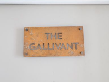 A metal sign with the words The Gallivant on a white wall at The Gallivant in Southwold
