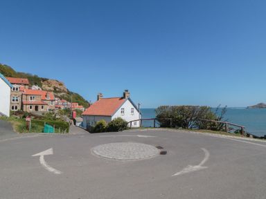 A roundabout with houses and coastline in Runswick Bay near Staithes