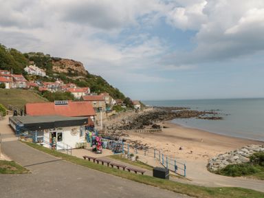 A beach with a shop and houses at Runswick Bay near Staithes