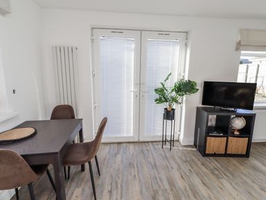 A dining room with a table and chairs at Old Colliery Cottage in Shilbottle
