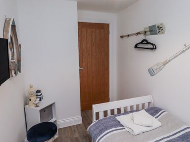 A bedroom with a bed and decorative items at Old Colliery Cottage in Shilbottle