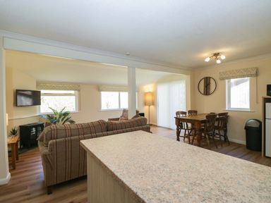 A living room with a sofa and dining table at Beech Timber Lodge in Keswick