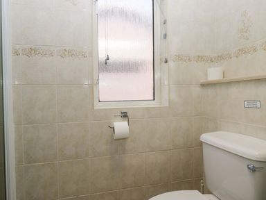 A bathroom with a toilet and window at Beech Timber Lodge in Keswick