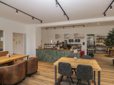 A cafe with tables and a counter at Elm Lodge in Keswick