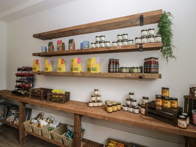 A store shelf with assorted jars and bags of goods at Elm Lodge in Keswick