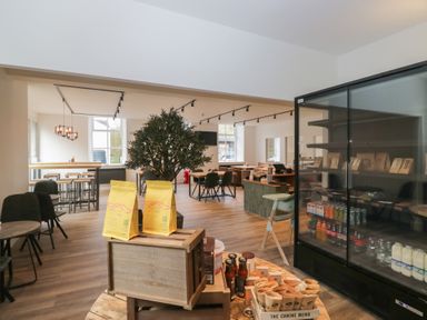 A cafe with tables and chairs at Elm Lodge in Keswick