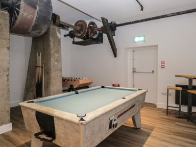 A game room with a pool table and foosball table at Elm Lodge in Keswick