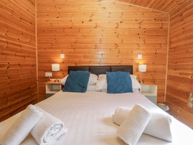 A bedroom with a bed and pillows at Elm Lodge in Keswick