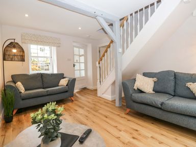 A living room with sofas and a coffee table at Riverside Cottage No 5 in Keswick