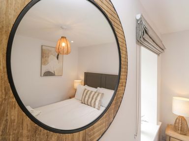 A bedroom with a bed and lamp at Riverside Cottage No 5 in Keswick