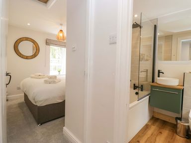 A bathroom with a bathtub and shower at Riverside Cottage No 5 Keswick