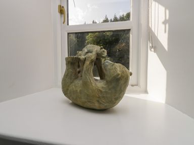 A sculpture of a bear playing with a cub on a windowsill at Greta House in Keswick