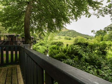 A view of a landscape with trees and hills at Derwent Lodge in Keswick