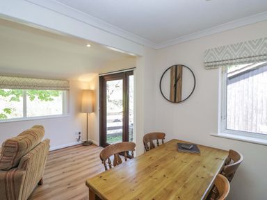 A dining room with a table and chairs at Chestnut Timber Lodge in Keswick