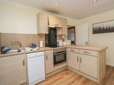 A kitchen with cabinets and appliances at Chestnut Timber Lodge in Keswick