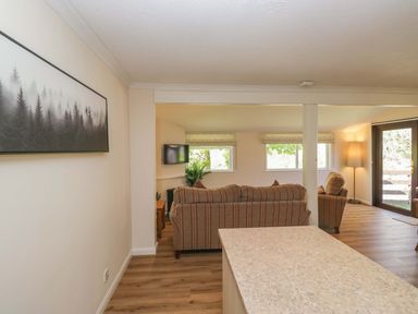 A living room with a sofa and television at Chestnut Timber Lodge in Keswick