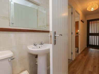 A bathroom with a sink and toilet at Chestnut Timber Lodge in Keswick