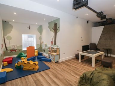 A playroom with colorful toys and a small table at Dogwood Timber Lodge in Keswick