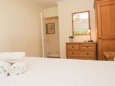 A bedroom with a bed and dresser at Dogwood Timber Lodge, Keswick