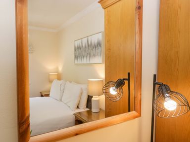 A bedroom with a bed and lamps at Dogwood Timber Lodge in Keswick