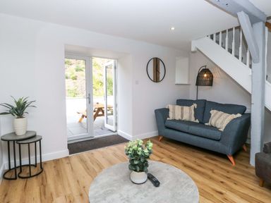 A living room with a sofa and coffee table at Riverside Cottage No 4 in Keswick